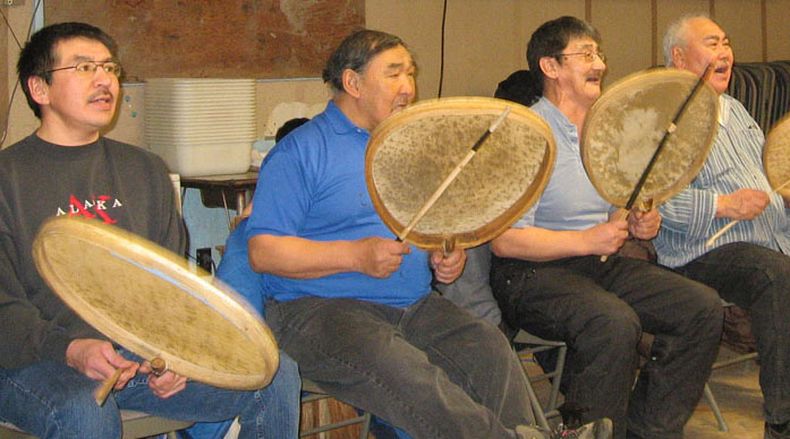People in blue jeans play drummers for dancers