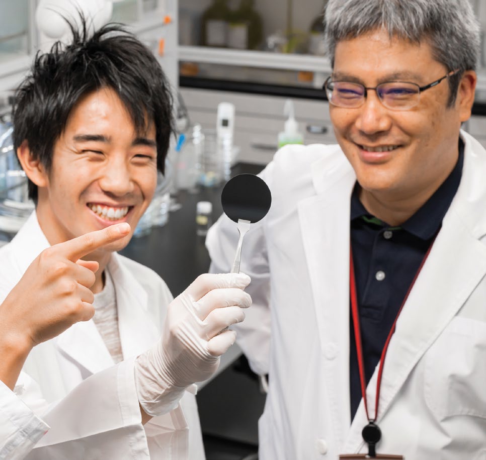 Shigenori Fujikawa with student holding up carbon dioxide filter membrane