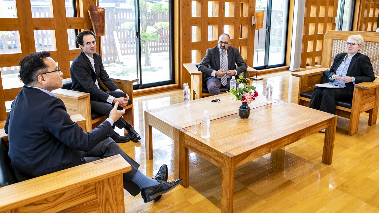 From left, Toshiyuki Kono, Daniel Rakove, Dan Zwigenberg, and Natalie Konomi chat while sitting in chairs around a table