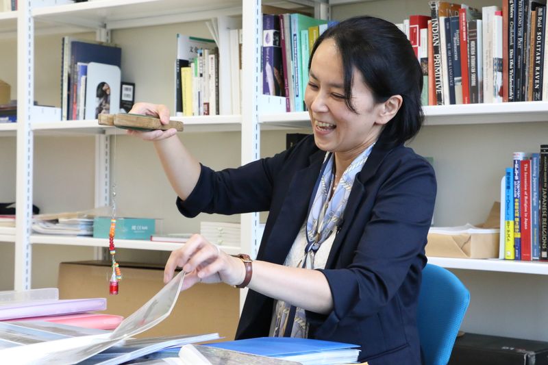 Hiroko Ikuta holds up fishing gear