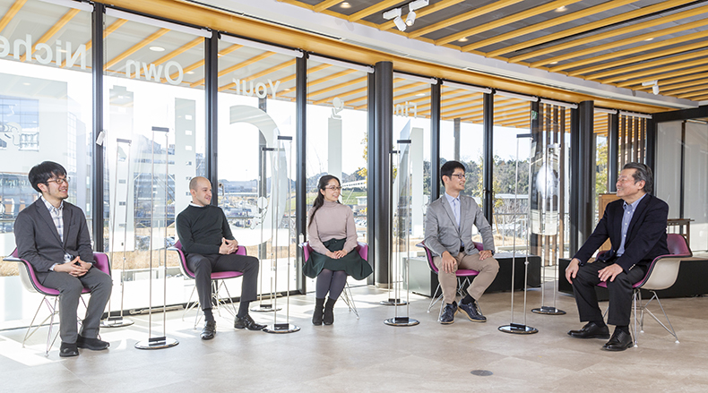 From left, Toshiyuki Kono, Daniel Rakove, Dan Zwigenberg, and Natalie Konomi chat while sitting in chairs around a table